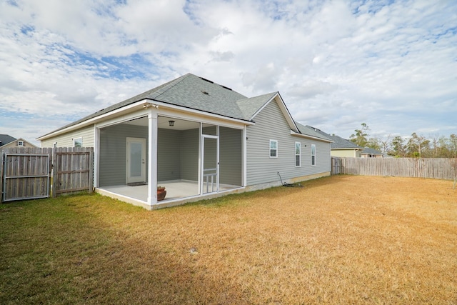 back of house with a patio and a lawn