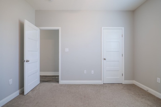 unfurnished bedroom with light colored carpet