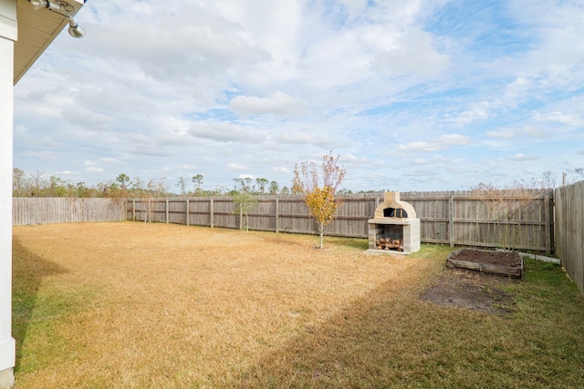 view of yard featuring a fireplace