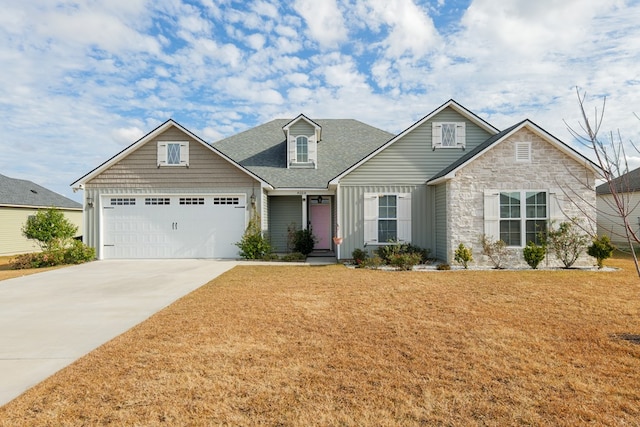 craftsman-style house featuring a garage and a front yard