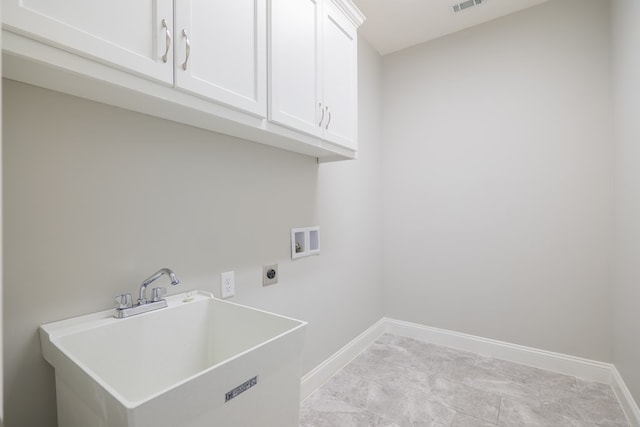 laundry area featuring cabinets, sink, hookup for an electric dryer, and hookup for a washing machine