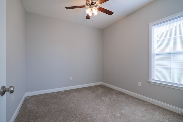 empty room featuring light carpet and ceiling fan