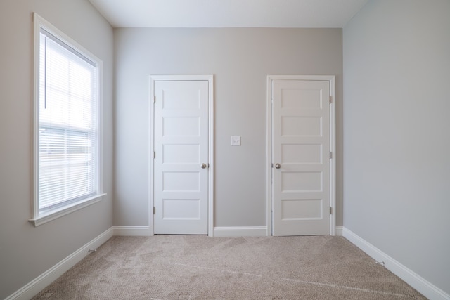 empty room featuring light colored carpet