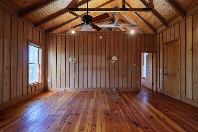 spare room featuring hardwood / wood-style floors, ceiling fan, vaulted ceiling with beams, and wooden ceiling