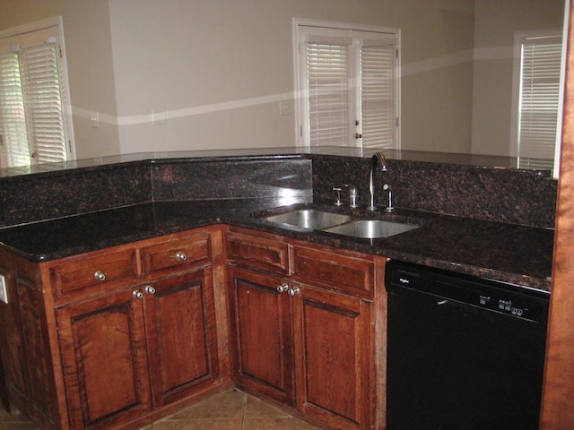 3745 Old Vine Way, Valdosta, GA 31605 - kitchen with black dishwasher, a sink, dark stone countertops, and light tile patterned floors