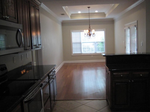 3745 Old Vine Way, Valdosta, GA 31605 - kitchen featuring stainless steel appliances, crown molding, a raised ceiling, a chandelier, and light tile patterned flooring