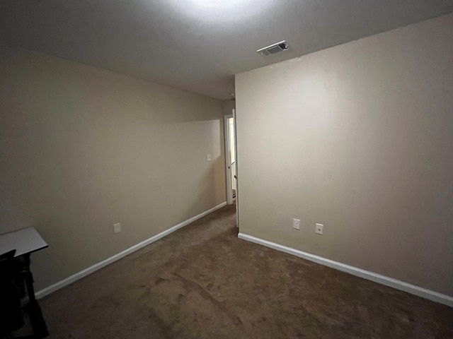 empty room with dark carpet