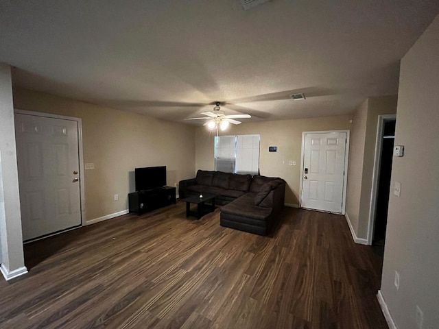 living room featuring dark hardwood / wood-style floors and ceiling fan