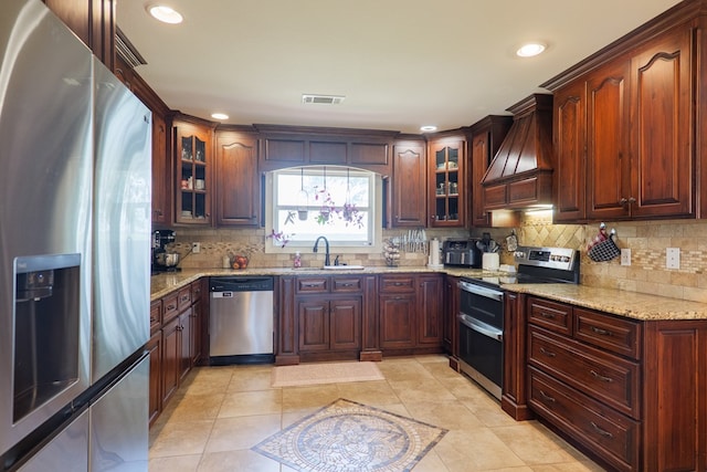 203 Murray Mccranie Rd, Norman Park, GA 31771 - kitchen with stainless steel appliances, custom range hood, decorative backsplash, light stone countertops, and recessed lighting