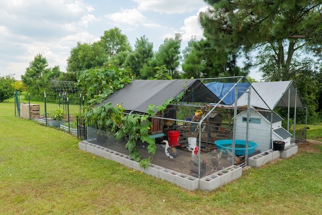 203 Murray Mccranie Rd, Norman Park, GA 31771 - back of house with exterior structure, a lawn, a garden, and an outbuilding