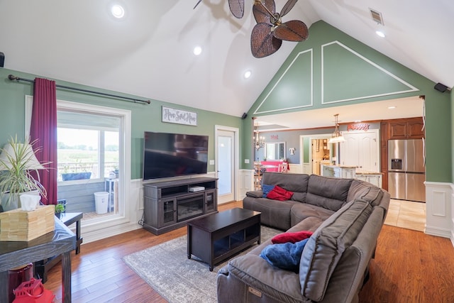 203 Murray Mccranie Rd, Norman Park, GA 31771 - living area with a wainscoted wall, a ceiling fan, a decorative wall, a chandelier, and light wood-style flooring