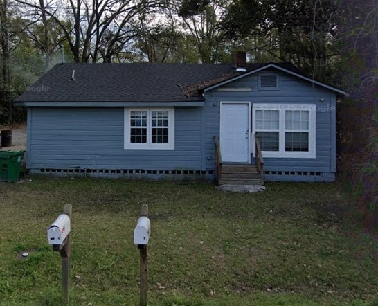 view of front of property featuring crawl space, a shingled roof, a front lawn, and entry steps