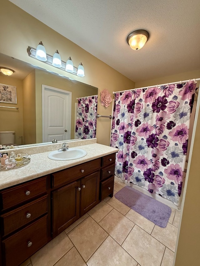 3650 Tupelo Rd, Valdosta, GA 31605 - bathroom with vanity, tile patterned flooring, toilet, a textured ceiling, and a shower with shower curtain