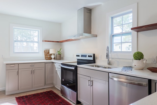 6041 NE Edmundson Rd, Hahira, GA 31632 - kitchen featuring open shelves, wall chimney exhaust hood, stainless steel appliances, a sink, and light wood-style floors