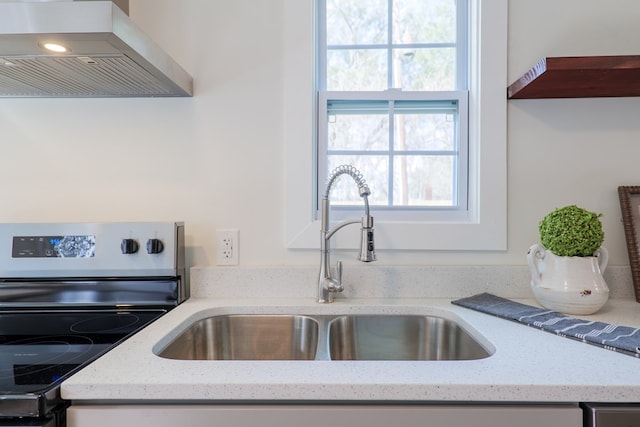 6041 NE Edmundson Rd, Hahira, GA 31632 - kitchen with electric range, wall chimney exhaust hood, a sink, and light stone countertops