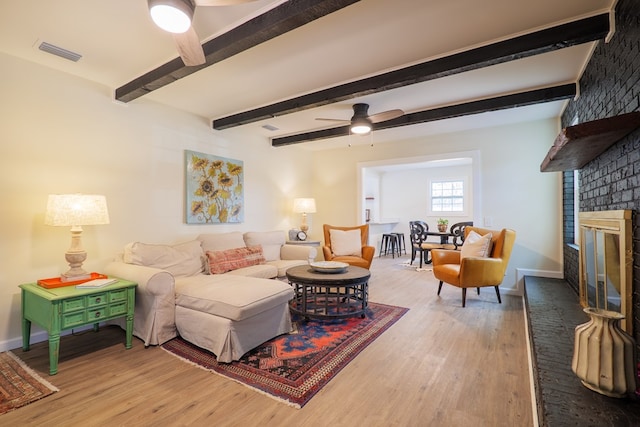 6041 NE Edmundson Rd, Hahira, GA 31632 - living area with ceiling fan, light wood-type flooring, baseboards, a brick fireplace, and beamed ceiling