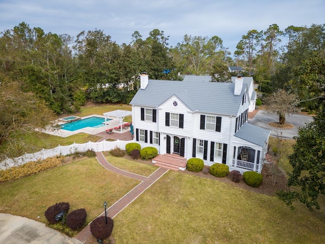 view of front of home with a patio area and a front yard