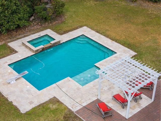 view of pool with a patio area, an in ground hot tub, a yard, and a diving board