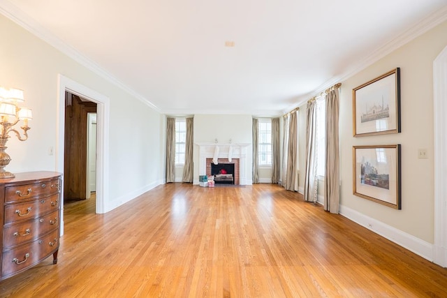 unfurnished living room with a brick fireplace, crown molding, and light hardwood / wood-style flooring