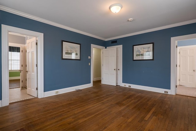 unfurnished bedroom featuring dark wood-type flooring and ornamental molding