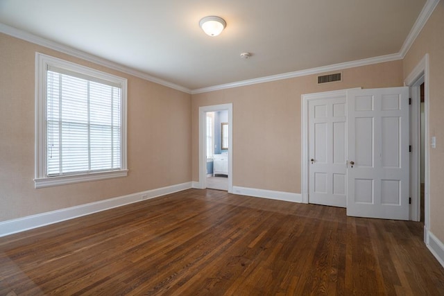 unfurnished bedroom featuring connected bathroom, a closet, dark hardwood / wood-style floors, and ornamental molding