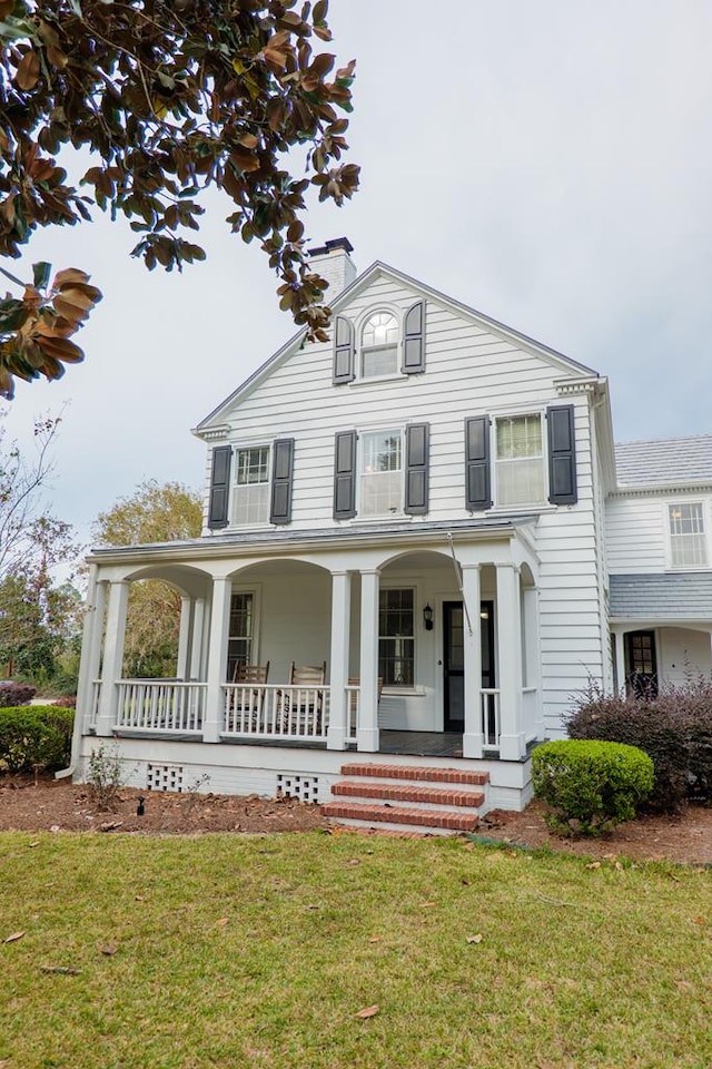 view of front of home with a front lawn and a porch