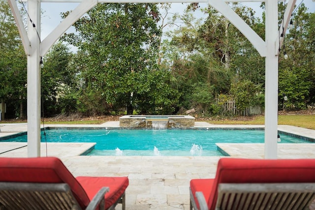 view of swimming pool with an in ground hot tub, pool water feature, and a patio