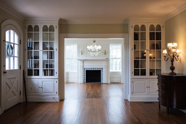 interior space featuring a tile fireplace, dark hardwood / wood-style floors, and ornamental molding