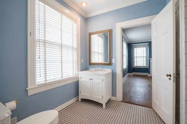 bathroom featuring wood-type flooring, vanity, toilet, and ornamental molding