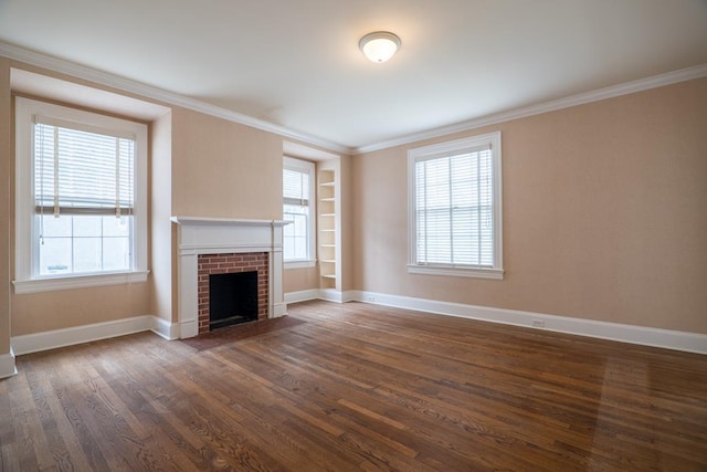 unfurnished living room with ornamental molding, dark hardwood / wood-style floors, and a brick fireplace