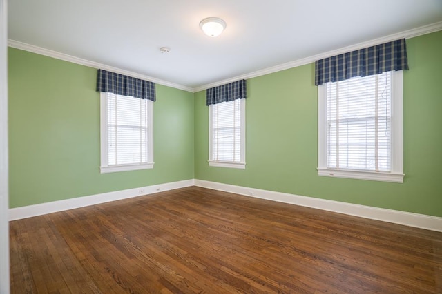 spare room with a wealth of natural light, crown molding, and dark hardwood / wood-style floors