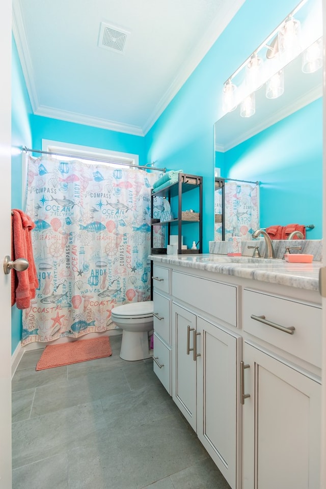 bathroom with ornamental molding, vanity, and toilet