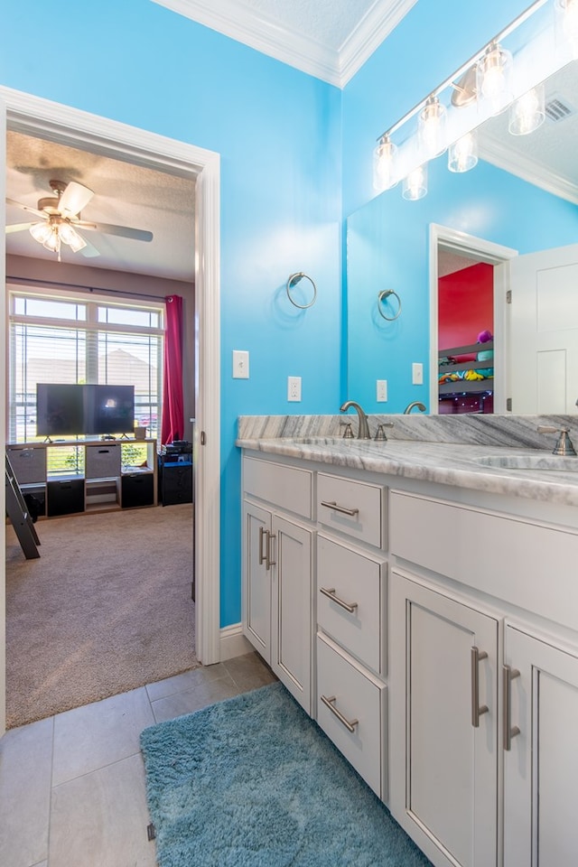 bathroom featuring tile patterned flooring, vanity, ornamental molding, and ceiling fan