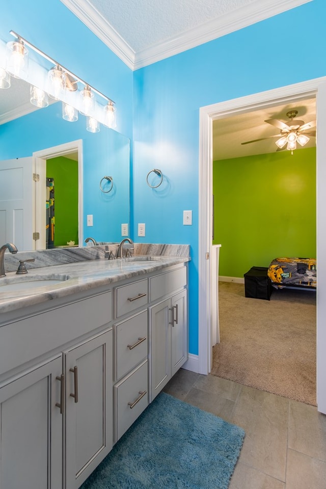 bathroom with vanity, ceiling fan, ornamental molding, and a textured ceiling