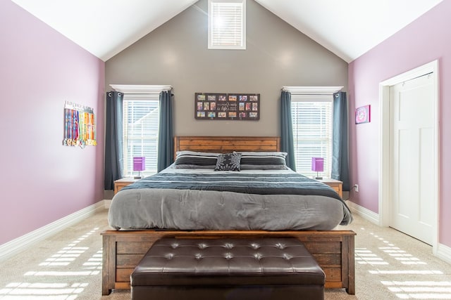 bedroom featuring lofted ceiling and light colored carpet