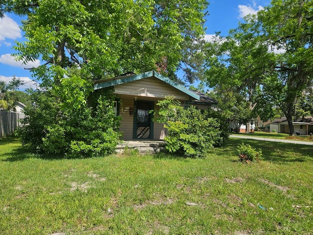 503 Jefferson St, Nashville, GA 31639 - obstructed view of property with a front yard, covered porch, and a chimney