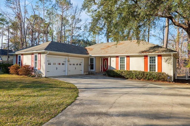 ranch-style home featuring a garage and a front yard