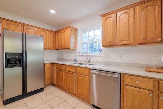 kitchen featuring light tile patterned flooring, sink, decorative backsplash, ornamental molding, and stainless steel appliances