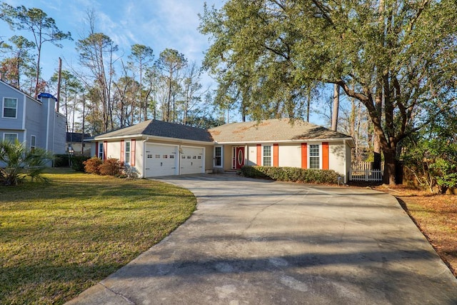 ranch-style house featuring a garage and a front lawn