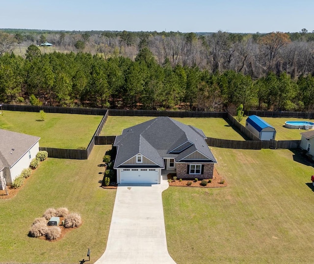 drone / aerial view with a wooded view