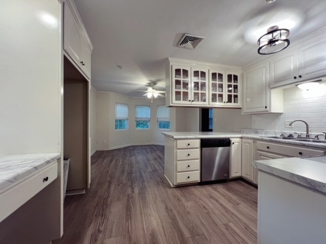 kitchen with white cabinets, dark hardwood / wood-style floors, and dishwasher