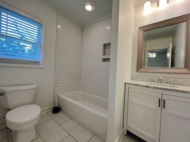 full bathroom with vanity, toilet, and tiled shower / bath combo