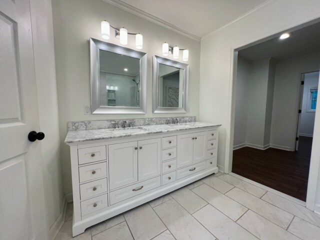 bathroom with hardwood / wood-style flooring, vanity, and ornamental molding