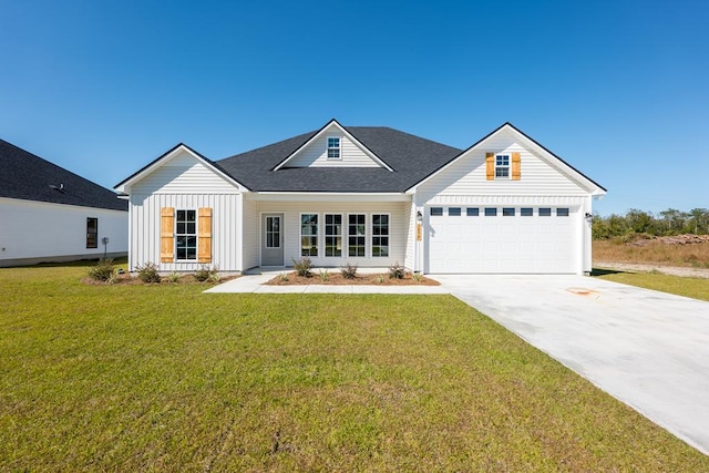 view of front of property featuring a front lawn and a garage