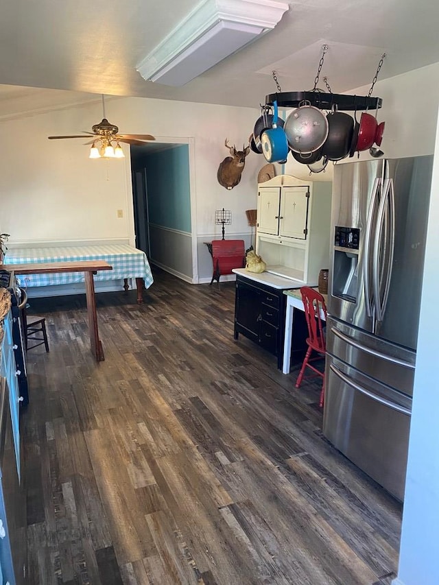 kitchen featuring ceiling fan, dark hardwood / wood-style floors, and stainless steel fridge with ice dispenser