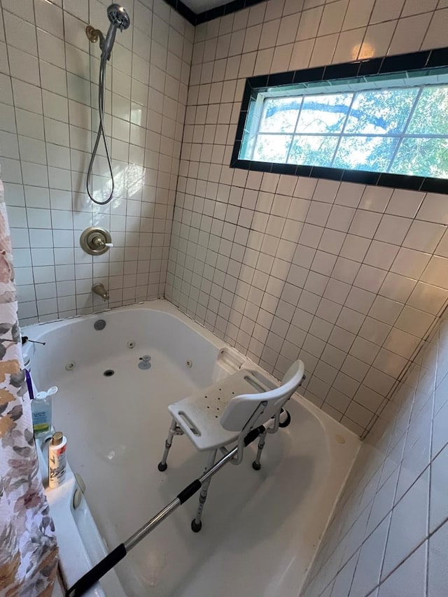 bathroom with tiled shower / bath and a wealth of natural light