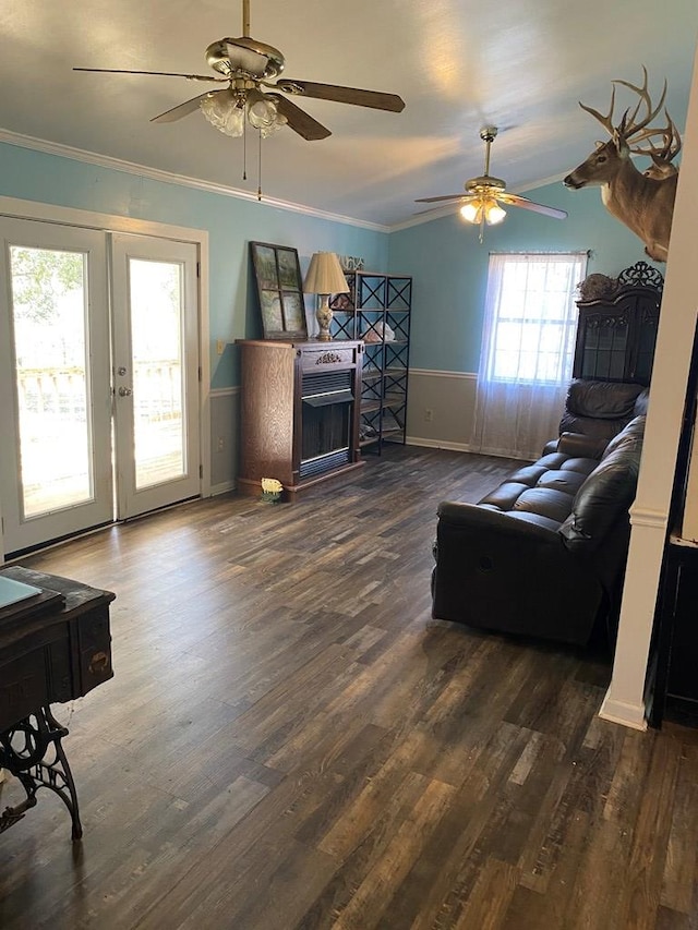 living room with lofted ceiling, dark wood-type flooring, ornamental molding, and french doors