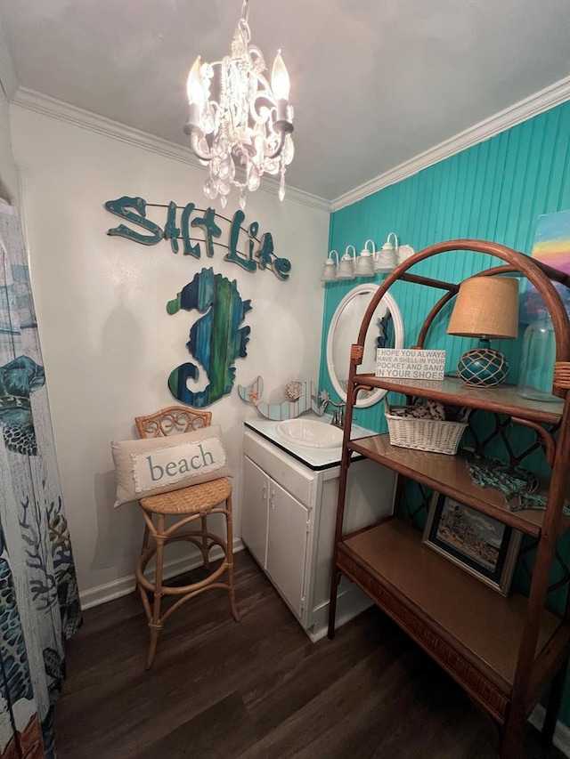 interior space featuring sink, a notable chandelier, ornamental molding, and dark hardwood / wood-style floors