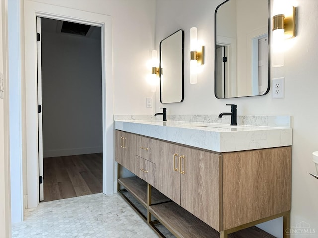 bathroom with double vanity and wood finished floors
