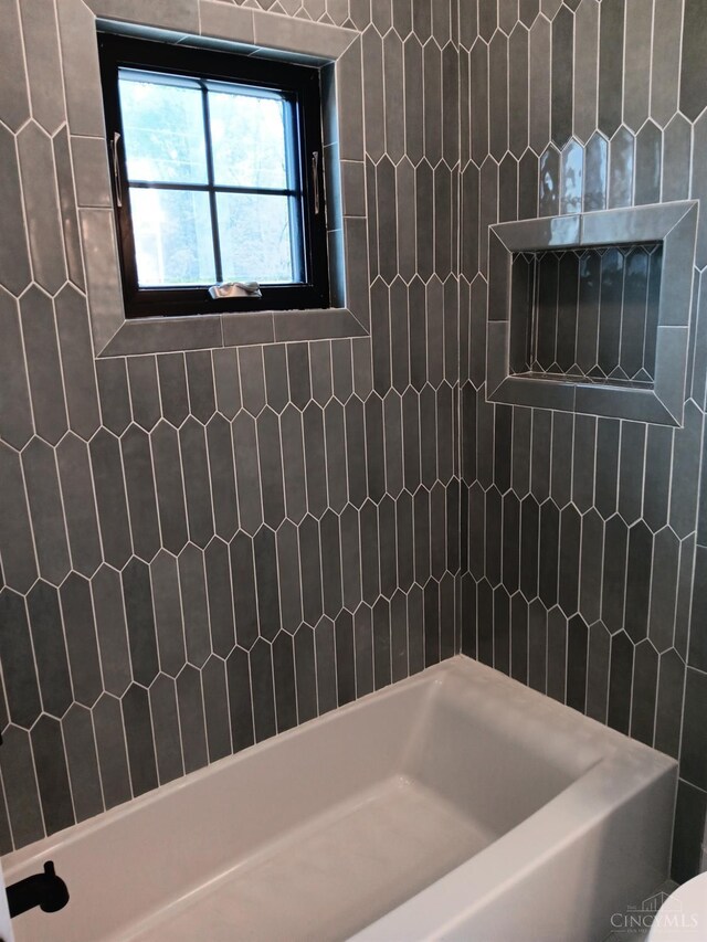 bathroom featuring a shower and a bathtub